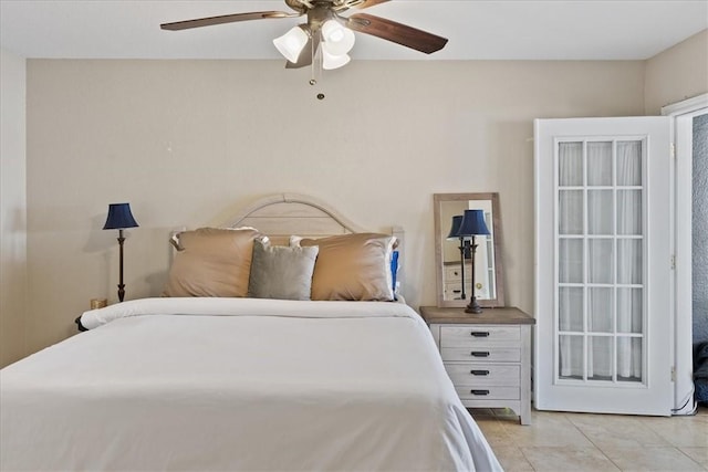 bedroom with ceiling fan and light tile patterned floors