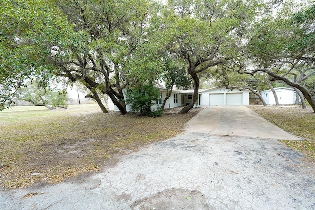 view of front of property with concrete driveway and an attached garage