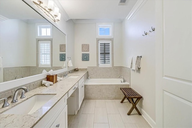 bathroom featuring tiled bath, ornamental molding, tile patterned flooring, and vanity