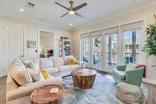 living room with ceiling fan, plenty of natural light, light hardwood / wood-style flooring, and french doors