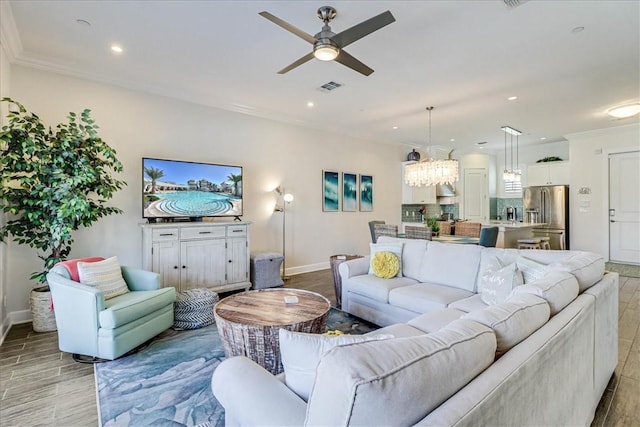 living room featuring ceiling fan, light hardwood / wood-style floors, and ornamental molding