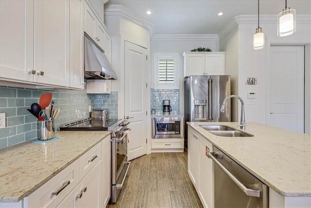 kitchen featuring a center island with sink, sink, white cabinetry, hanging light fixtures, and appliances with stainless steel finishes