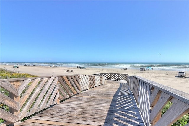 view of community with a beach view and a water view