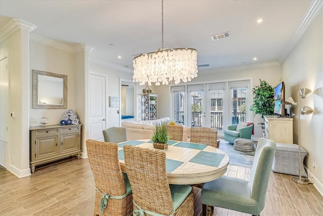 dining area featuring ornamental molding and an inviting chandelier