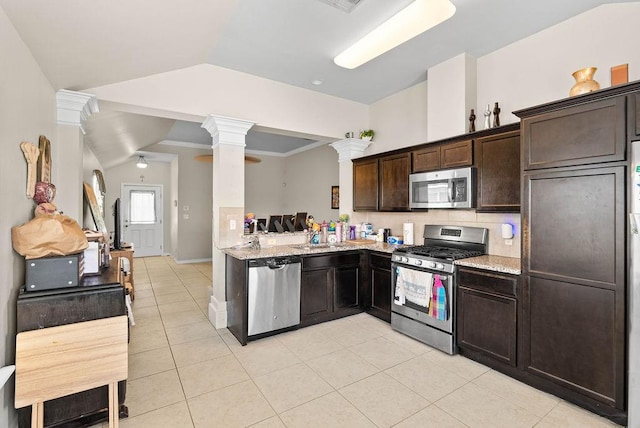 7418 Oshman Dr, Corpus Christi, TX 78414 - kitchen with stainless steel appliances, decorative columns, dark brown cabinetry, light tile patterned floors, and light stone countertops