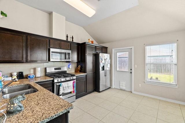 7418 Oshman Dr, Corpus Christi, TX 78414 - kitchen featuring stainless steel appliances, a sink, lofted ceiling, light stone countertops, and backsplash