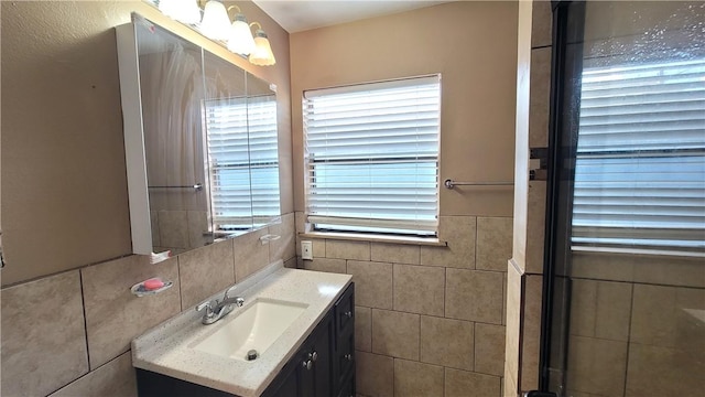 bathroom with vanity and tile walls