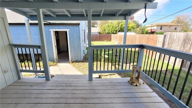 deck with a lawn and a storage shed