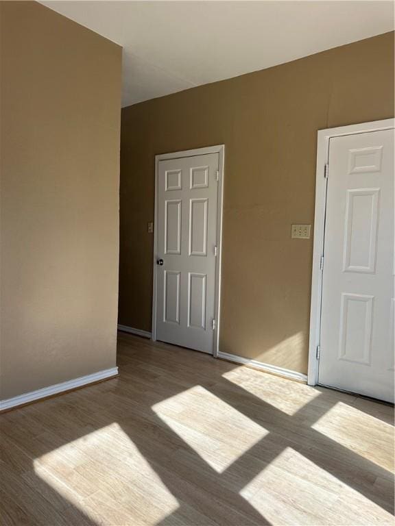 empty room with wood-type flooring