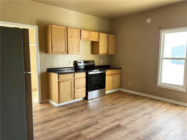 empty room with light hardwood / wood-style floors and a textured ceiling