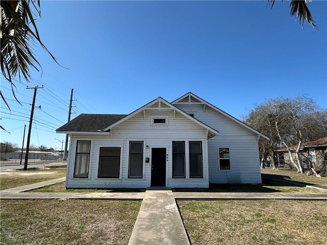 bungalow-style home featuring a front yard