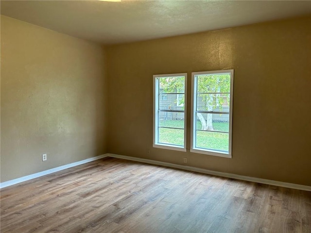 616 Hall St Unit A & B, Sinton, TX 78387 - spare room featuring wood finished floors, baseboards, and a textured wall