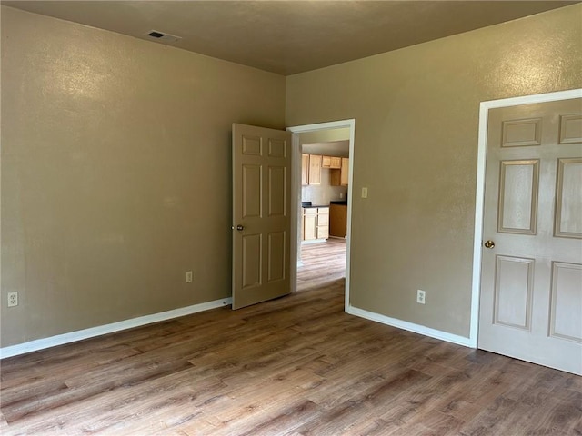 616 Hall St Unit A & B, Sinton, TX 78387 - unfurnished bedroom with visible vents, baseboards, and wood finished floors