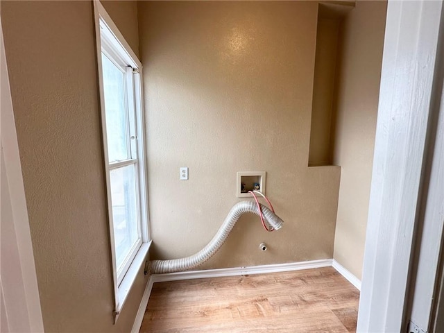 laundry room featuring hookup for a washing machine, gas dryer hookup, and light hardwood / wood-style flooring