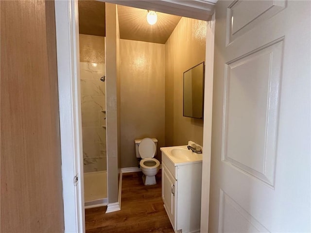 616 Hall St Unit A & B, Sinton, TX 78387 - bathroom featuring baseboards, toilet, wood finished floors, vanity, and a shower