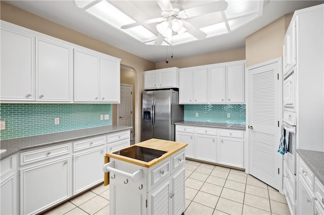14106 Palo Seco Dr, Corpus Christi, TX 78418 - kitchen featuring decorative backsplash, light tile patterned floors, white appliances, and white cabinets