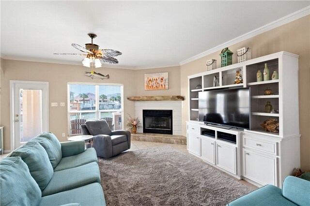 14106 Palo Seco Dr, Corpus Christi, TX 78418 - living area featuring light tile patterned floors, a ceiling fan, a glass covered fireplace, and ornamental molding