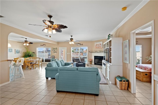 14106 Palo Seco Dr, Corpus Christi, TX 78418 - living room featuring a fireplace with raised hearth, a wealth of natural light, ceiling fan, and light tile patterned floors