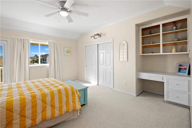 14106 Palo Seco Dr, Corpus Christi, TX 78418 - bedroom featuring a closet, built in study area, light carpet, baseboards, and lofted ceiling