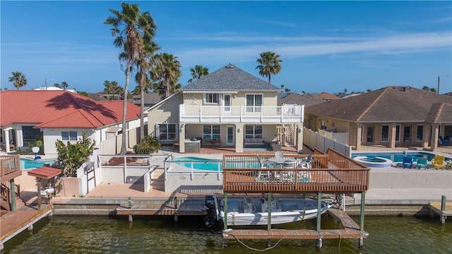 14106 Palo Seco Dr, Corpus Christi, TX 78418 - back of property featuring a balcony, an outdoor pool, a water view, a patio, and an in ground hot tub