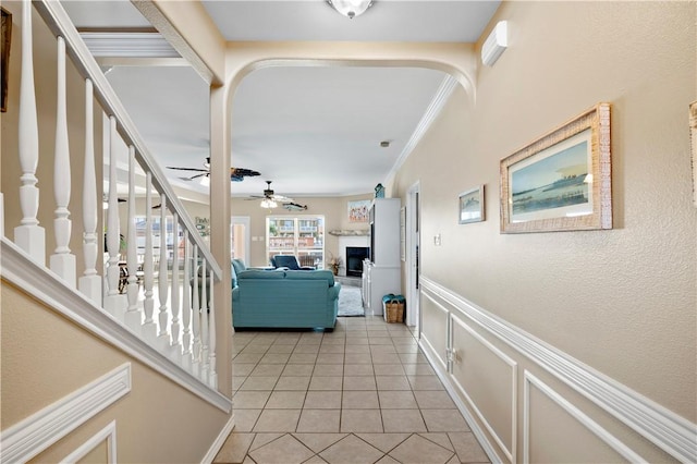 14106 Palo Seco Dr, Corpus Christi, TX 78418 - hallway with light tile patterned flooring, wainscoting, crown molding, stairs, and a decorative wall