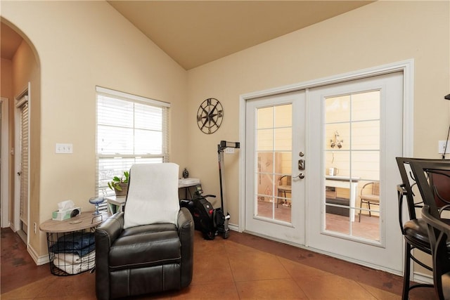 living area with tile patterned flooring, arched walkways, vaulted ceiling, and french doors