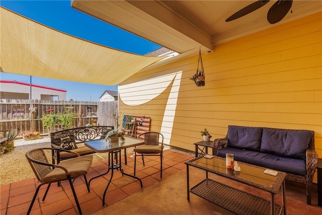 view of patio / terrace featuring ceiling fan, fence, and an outdoor hangout area