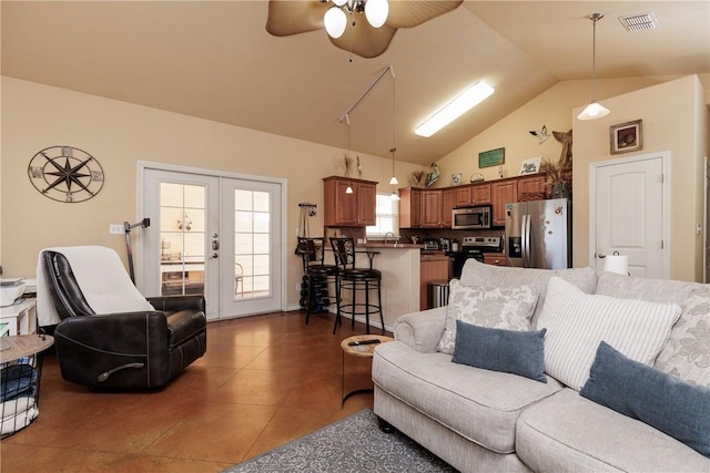 living area featuring french doors, visible vents, a ceiling fan, high vaulted ceiling, and dark tile patterned flooring