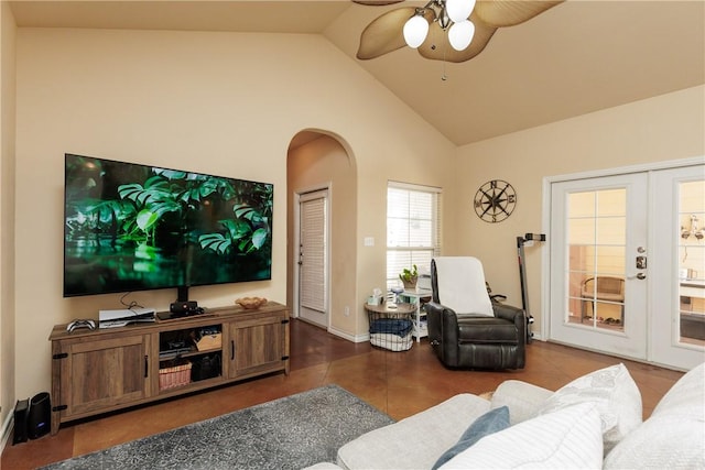 tiled living room with a ceiling fan, arched walkways, french doors, and high vaulted ceiling