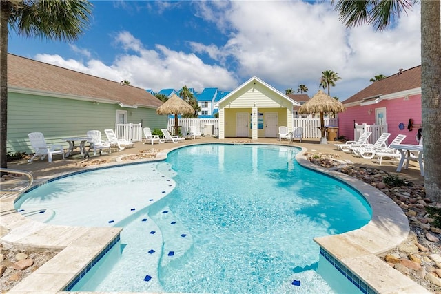 pool with fence and a patio