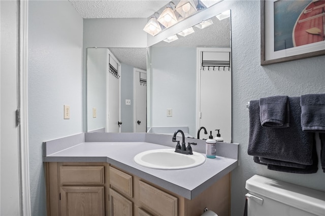 14721 Whitecap Blvd Unit 344, Corpus Christi, TX 78418 - bathroom featuring a textured ceiling, vanity, and a textured wall