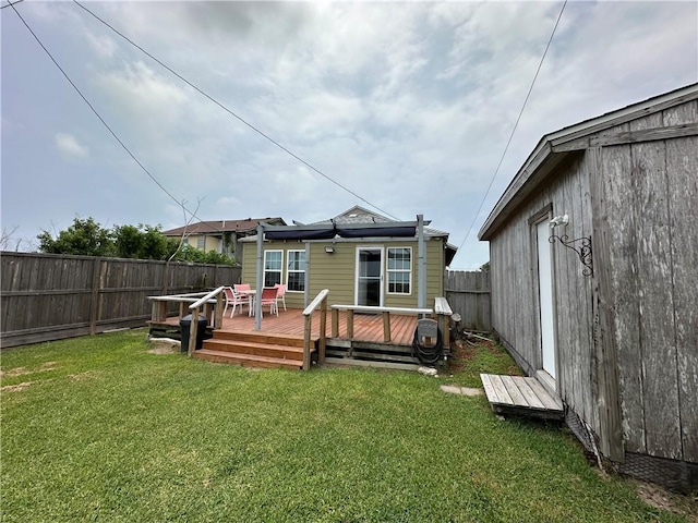 230 Lola Johnson, Corpus Christi, TX 78418 - rear view of house featuring a yard, a wooden deck, and a fenced backyard