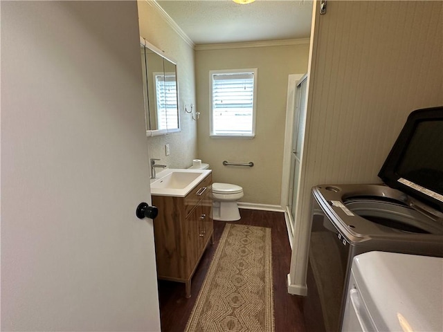 230 Lola Johnson, Corpus Christi, TX 78418 - bathroom featuring washing machine and clothes dryer, toilet, wood finished floors, and a stall shower