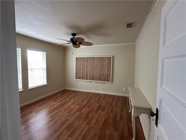 230 Lola Johnson, Corpus Christi, TX 78418 - spare room featuring visible vents, dark wood-style flooring, baseboards, ceiling fan, and ornamental molding