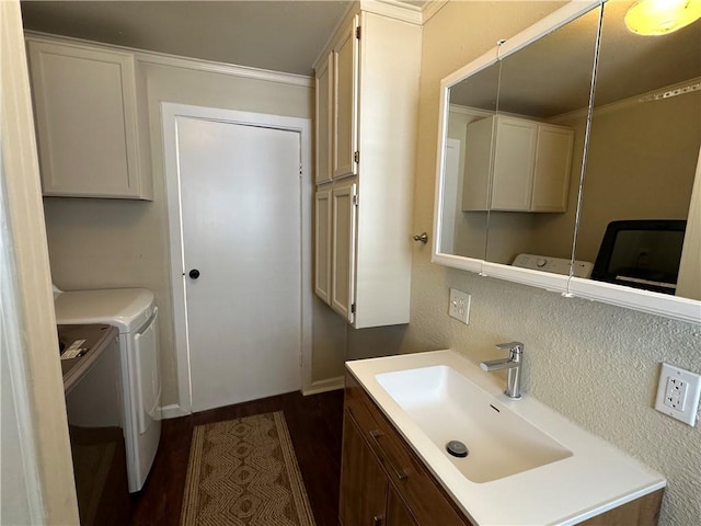 230 Lola Johnson, Corpus Christi, TX 78418 - bathroom featuring washer and dryer, crown molding, wood finished floors, and vanity