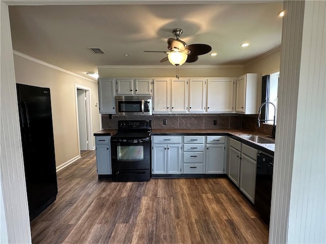 230 Lola Johnson, Corpus Christi, TX 78418 - kitchen with dark countertops, dark wood-style floors, black appliances, and a sink
