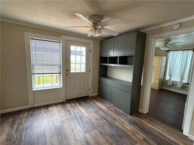 230 Lola Johnson, Corpus Christi, TX 78418 - doorway featuring a ceiling fan, dark wood finished floors, crown molding, and a textured ceiling