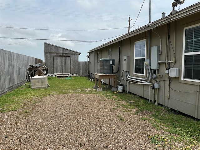 230 Lola Johnson, Corpus Christi, TX 78418 - view of yard with an outdoor structure, fence, a storage unit, and central AC