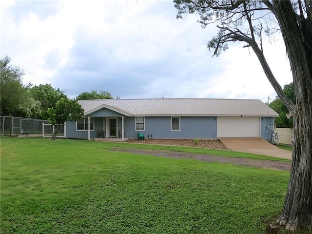 4625 Harney Rd, Corpus Christi, TX 78410 - view of front of house featuring driveway, an attached garage, and a metal roof