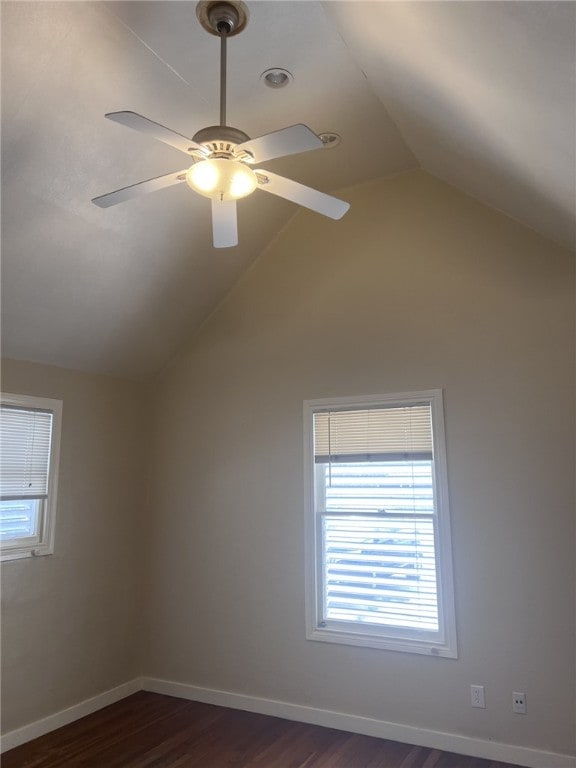 additional living space featuring lofted ceiling, dark hardwood / wood-style floors, and ceiling fan