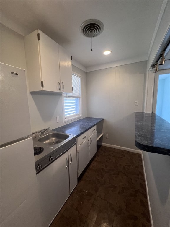 kitchen featuring white cabinets