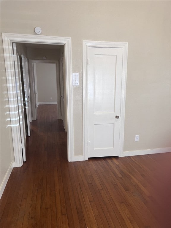 hallway with dark hardwood / wood-style floors