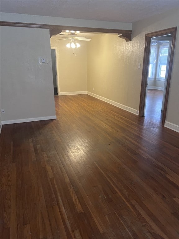 spare room featuring dark hardwood / wood-style floors and ceiling fan