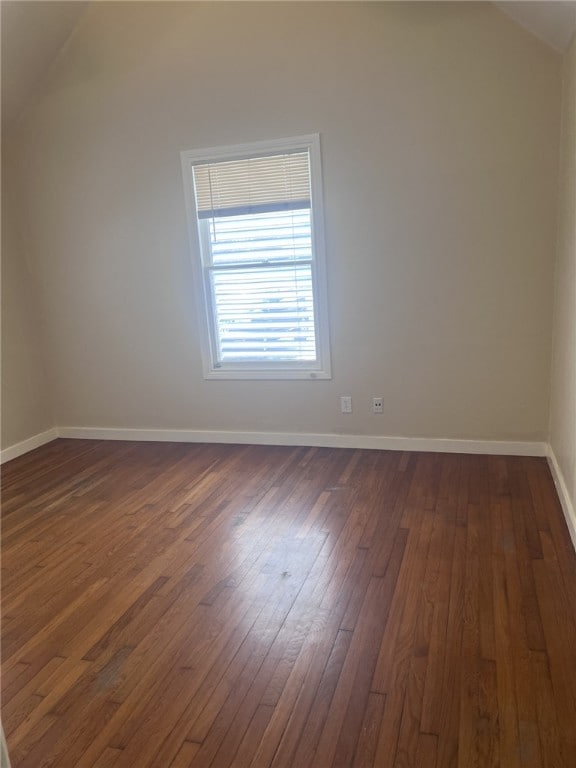 bonus room with lofted ceiling and dark hardwood / wood-style floors