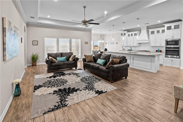 4133 Midlands St, Corpus Christi, TX 78414 - living room featuring light wood-style floors, a ceiling fan, crown molding, recessed lighting, and a tray ceiling