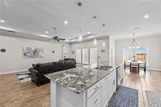 4133 Midlands St, Corpus Christi, TX 78414 - kitchen with white cabinets, healthy amount of natural light, light wood-style floors, a kitchen island with sink, and recessed lighting