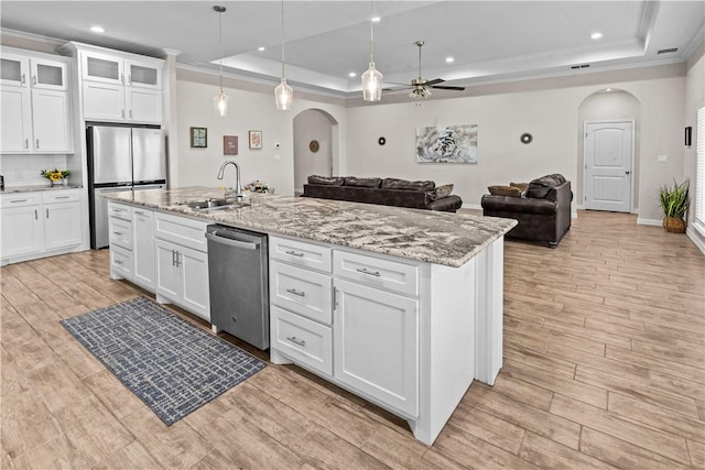 4133 Midlands St, Corpus Christi, TX 78414 - kitchen featuring stainless steel appliances, arched walkways, a raised ceiling, a ceiling fan, and ornamental molding