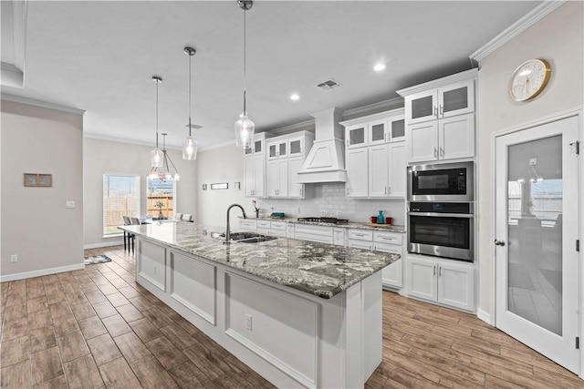 4133 Midlands St, Corpus Christi, TX 78414 - kitchen featuring appliances with stainless steel finishes, custom exhaust hood, crown molding, white cabinets, and recessed lighting