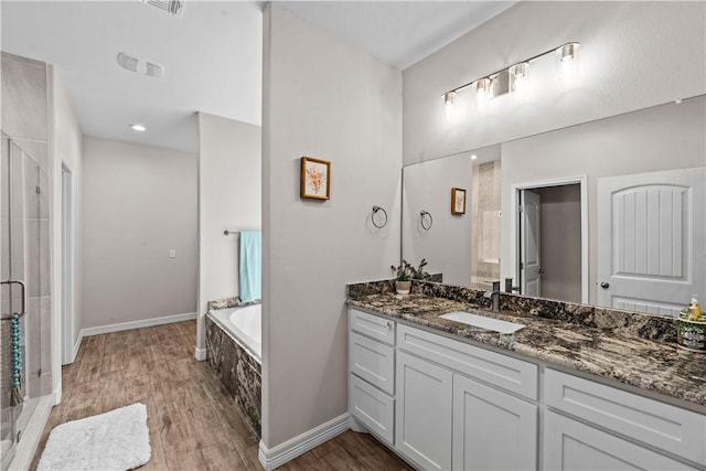 4133 Midlands St, Corpus Christi, TX 78414 - bathroom with wood finished floors, vanity, a garden tub, and a stall shower