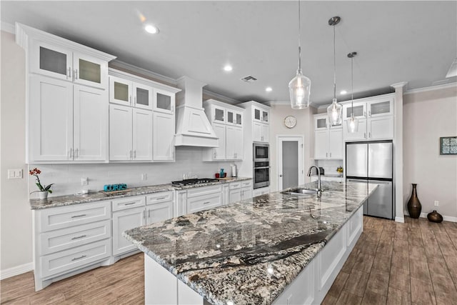 4133 Midlands St, Corpus Christi, TX 78414 - kitchen featuring stainless steel appliances, custom exhaust hood, a large island, tasteful backsplash, and white cabinetry
